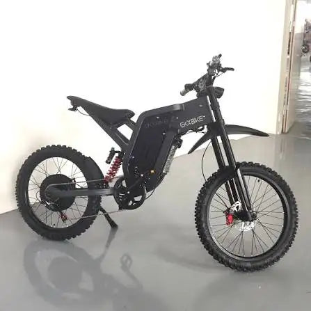 Black electric mountain bike side view with integrated battery, fat tires, disc brakes.