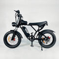 Black electric fat-tire bike with mounted battery, front fork suspension, disc brakes