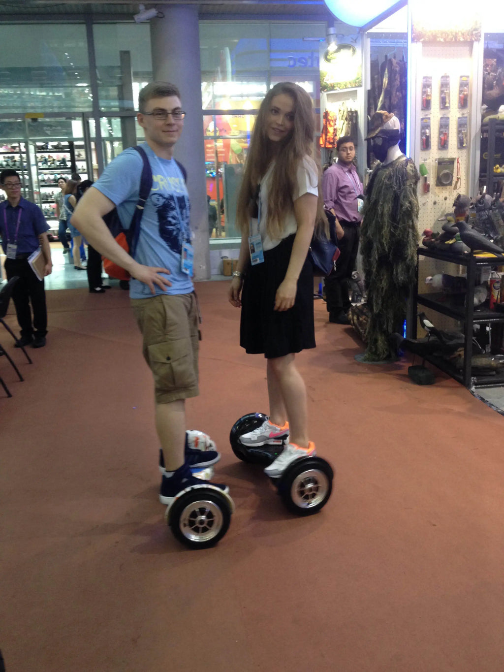 White hoverboard with blue lights, standing on two wheels