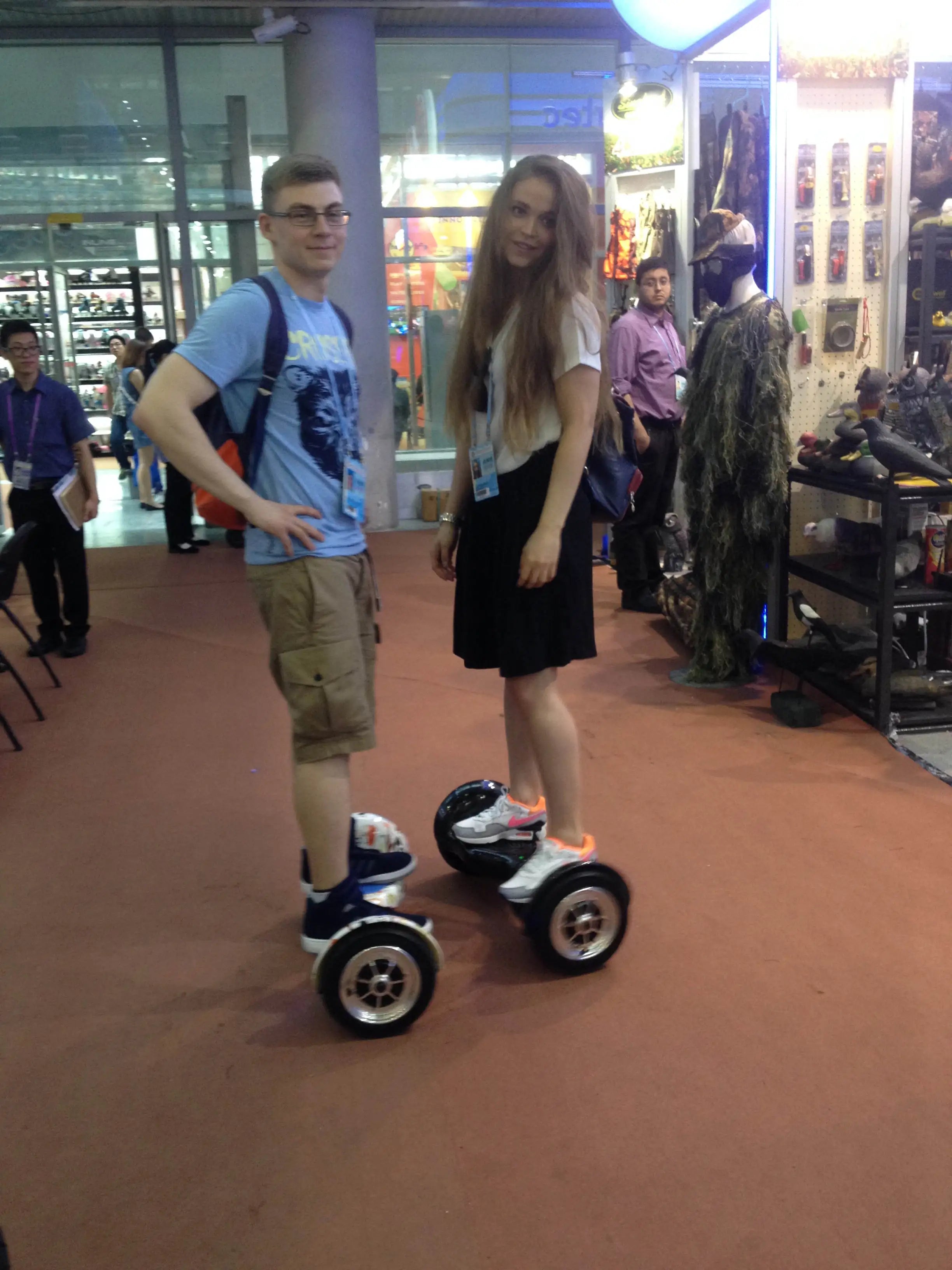 White hoverboard with blue lights, standing on two wheels