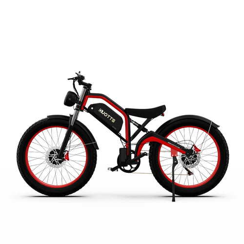Electric mountain bike with black frame, red accents, fat tires and front headlight