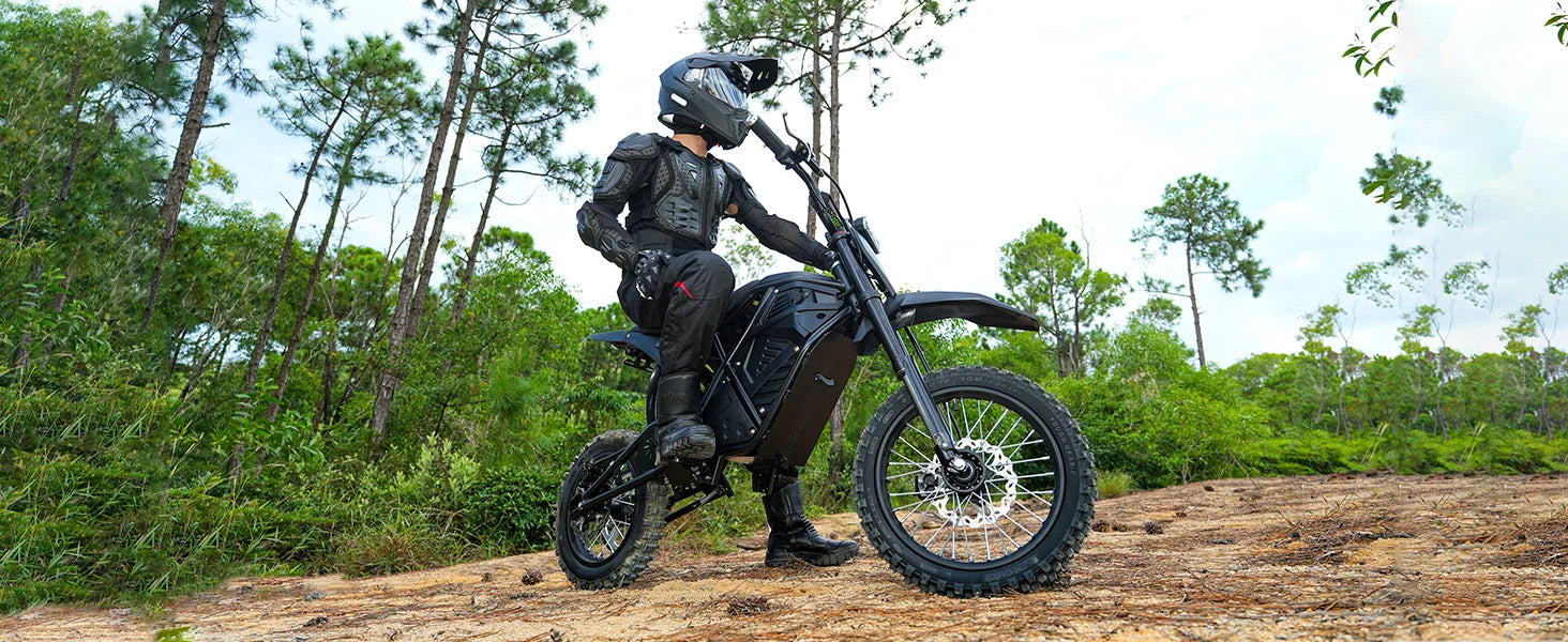 Electric dirt bike with rider, front disc brake and spoked knobby tires