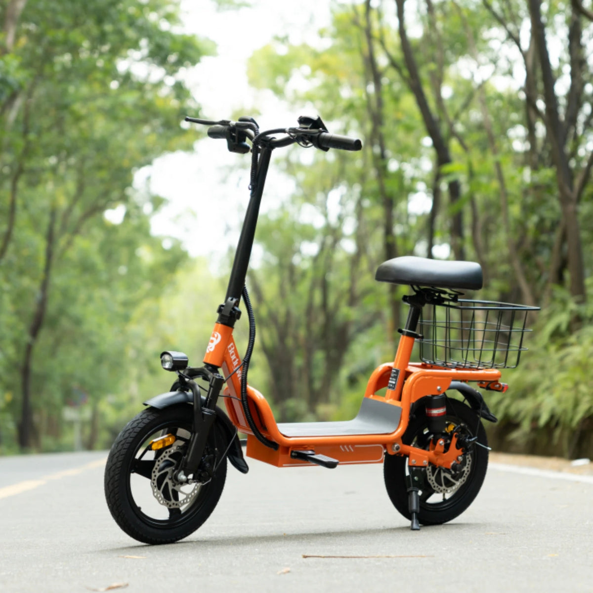 Orange folding electric bike, side view, with front wire basket and saddle